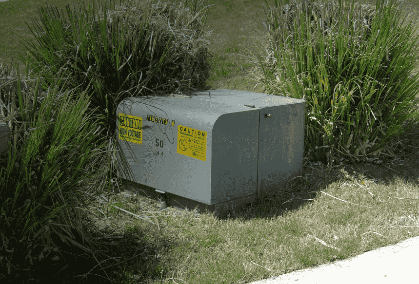 tall grass makes pad-mounted transformer difficult to access